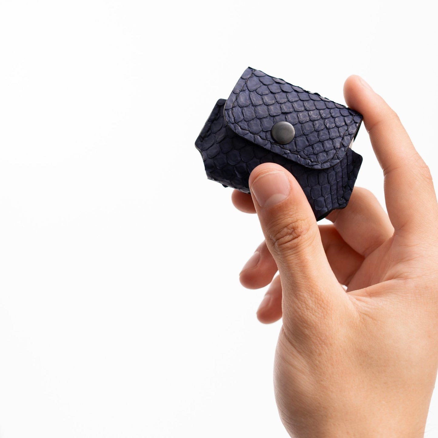 Case for AirPods made of dark blue python leather with small scales