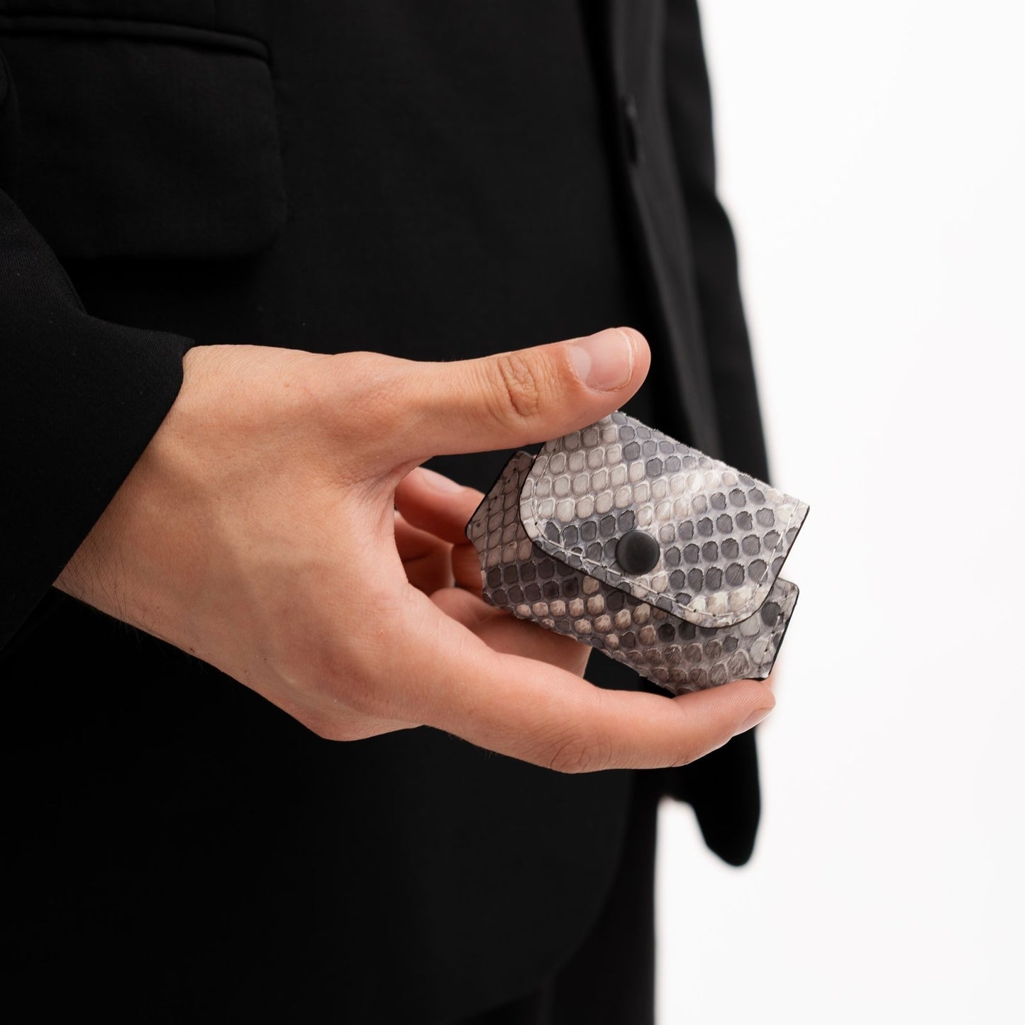 Case for AirPods made of black and white python leather with small scales