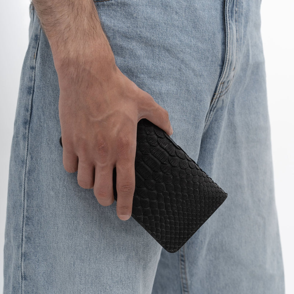 Wallet made of black python leather with wide scales