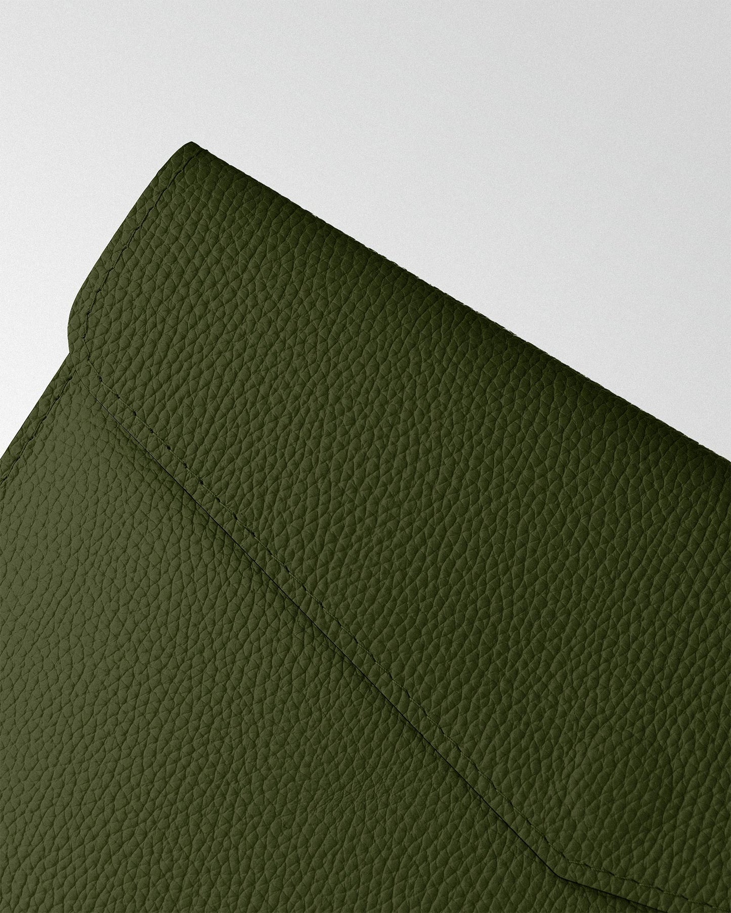 Magnetic case made of dark green textured leather for MacBook