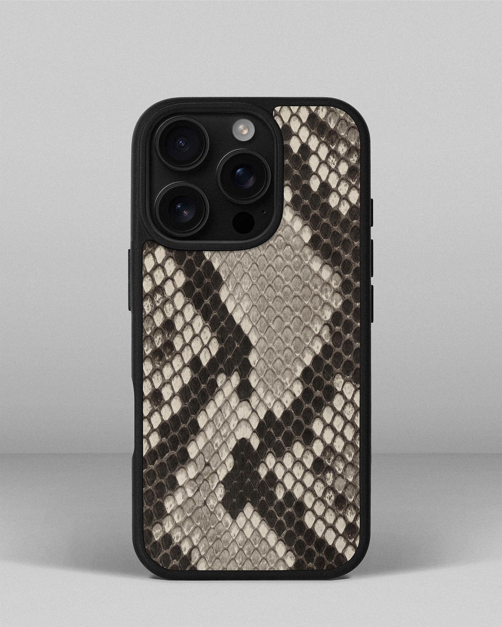 Case made of black and white python leather with small scales for iPhone 16 Pro