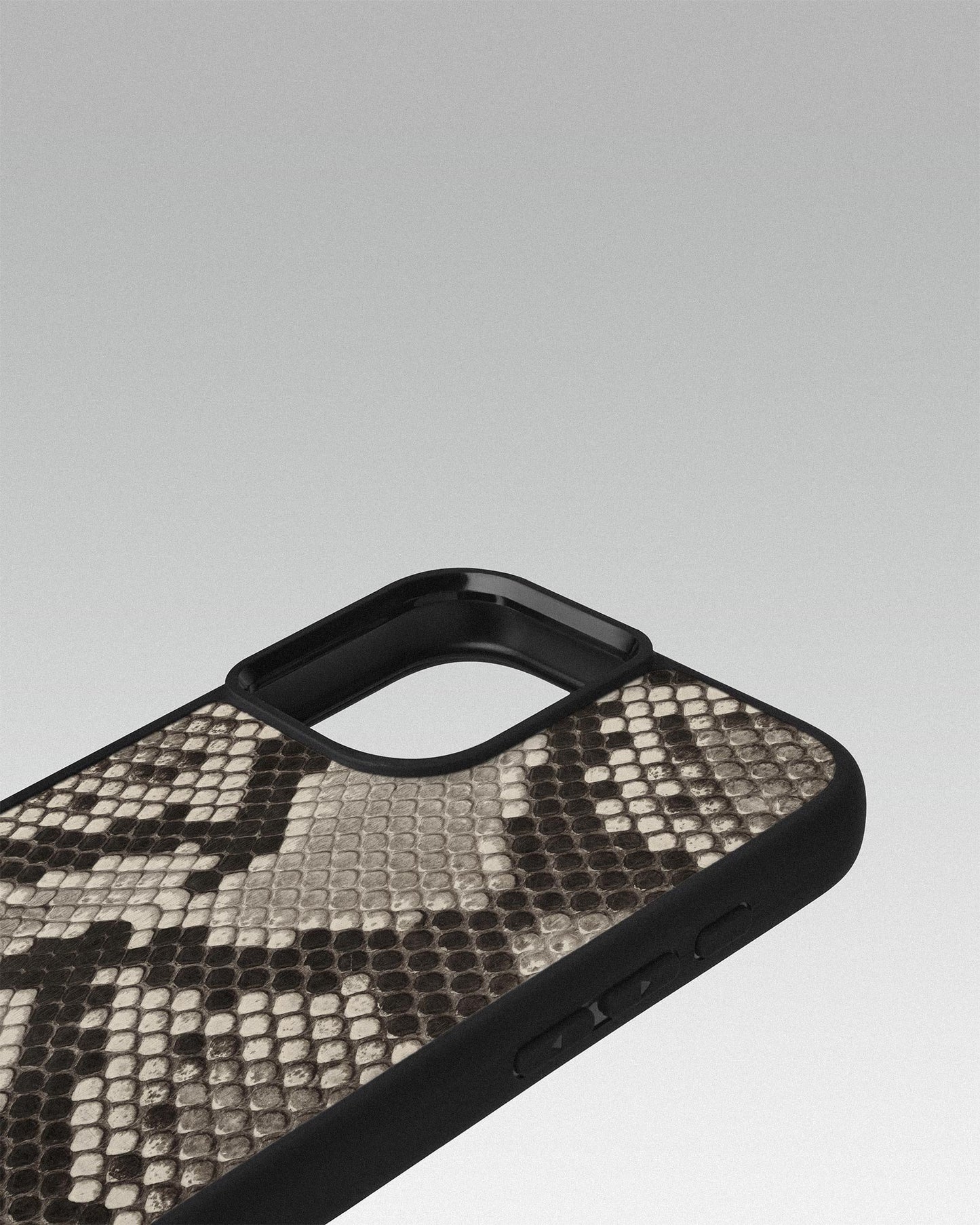 Case made of black and white python leather with small scales for iPhone 16 Plus