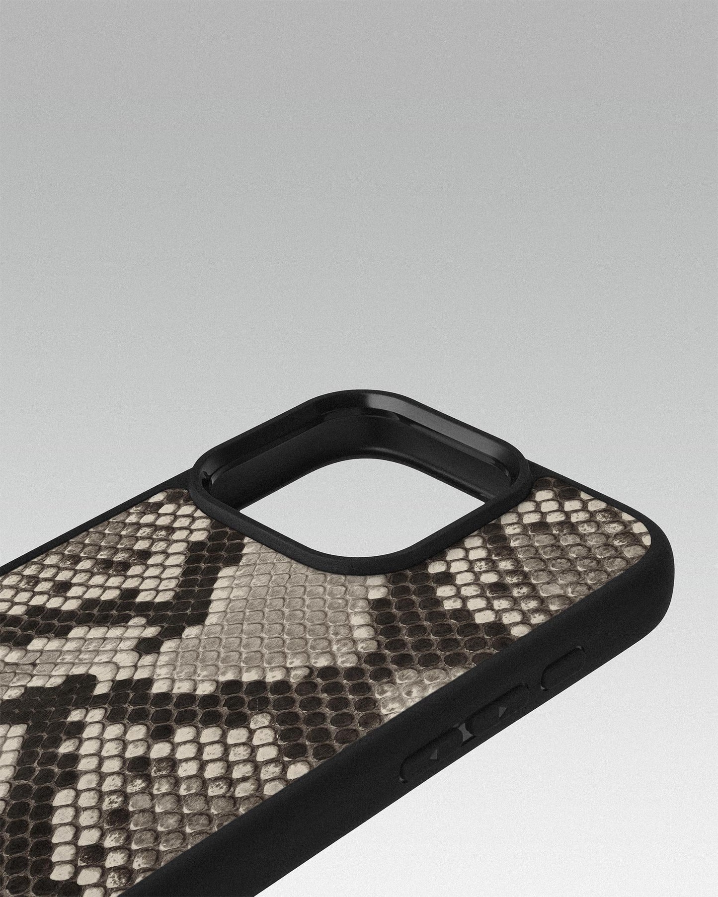Case made of black and white python leather with small scales for iPhone 16 Pro Max