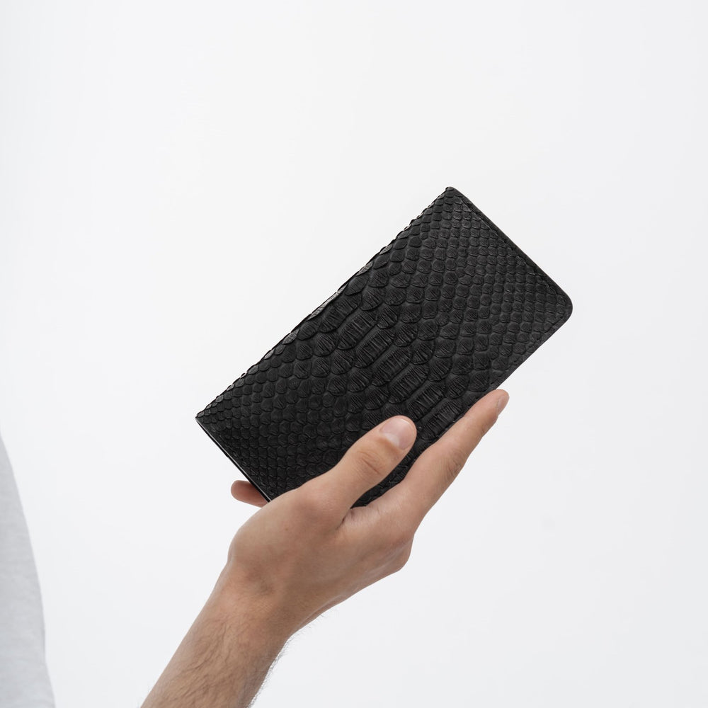 Wallet made of black python leather with wide scales